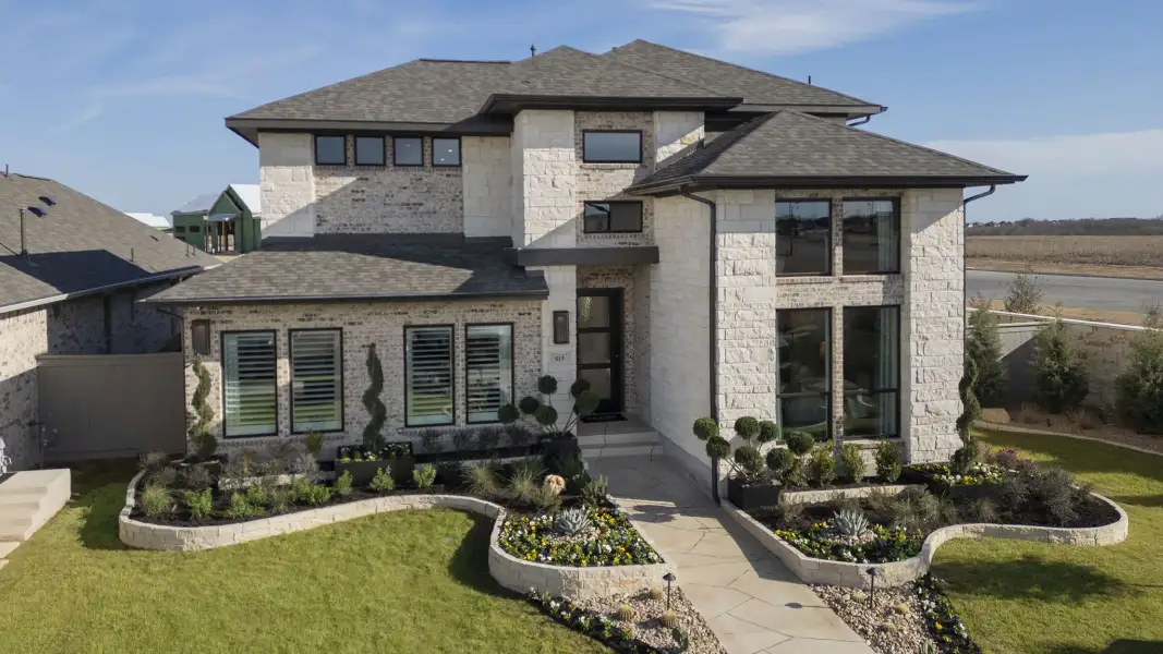 Front exterior of a new home in Artavia, Conroe, TX, highlighting curb appeal (Image 21).