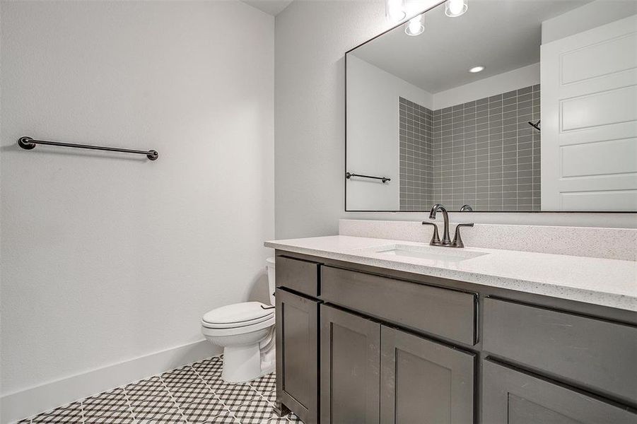 Bathroom with tile patterned flooring, toilet, and vanity