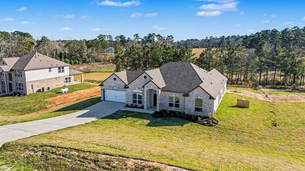 Front exterior of a new home in Rose Hill Estates, Willis, TX, highlighting curb appeal (Image 22).