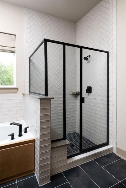 This additional view of your primary bathroom features tile flooring, fresh paint, walk-in shower, a separate garden tub, and a large walk-in closet. This additional view of your primary bathroom features tile flooring, fresh paint, walk-in shower, a separate garden tub, and a large walk-in closet.