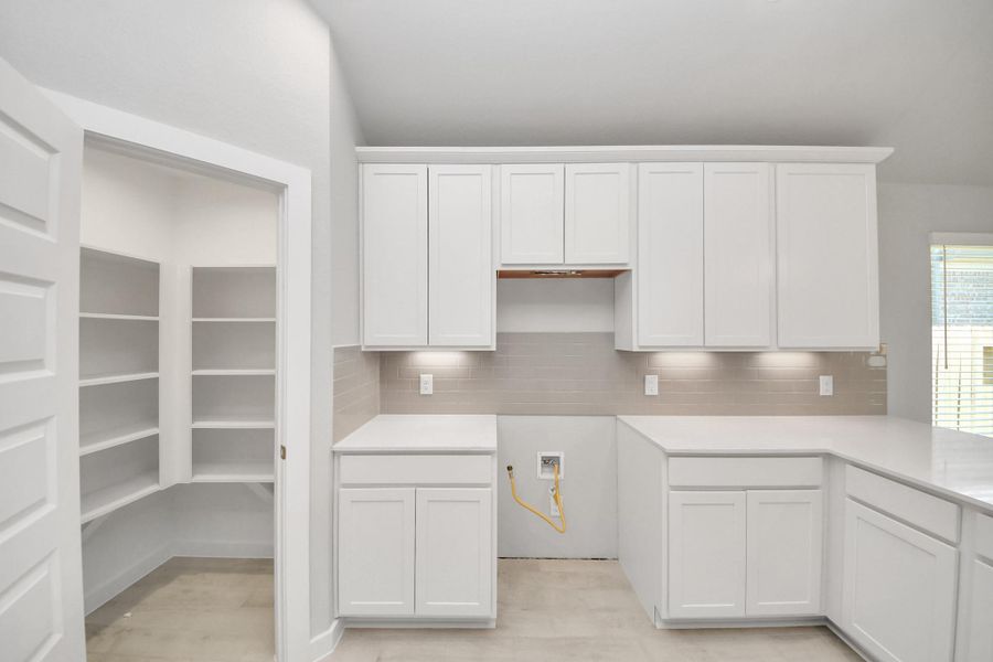This generously spacious kitchen is a dream realized! Sample photo of completed home with similar floor plan. Actual colors and selections may vary. This generously spacious kitchen is a dream realized! Sample photo of completed home with similar floor plan. Actual colors and selections may vary.