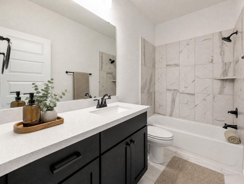 Clean lines define this bright bathroom, featuring a modern vanity and tiled shower-tub combo. Clean lines define this bright bathroom, featuring a modern vanity and tiled shower-tub combo.