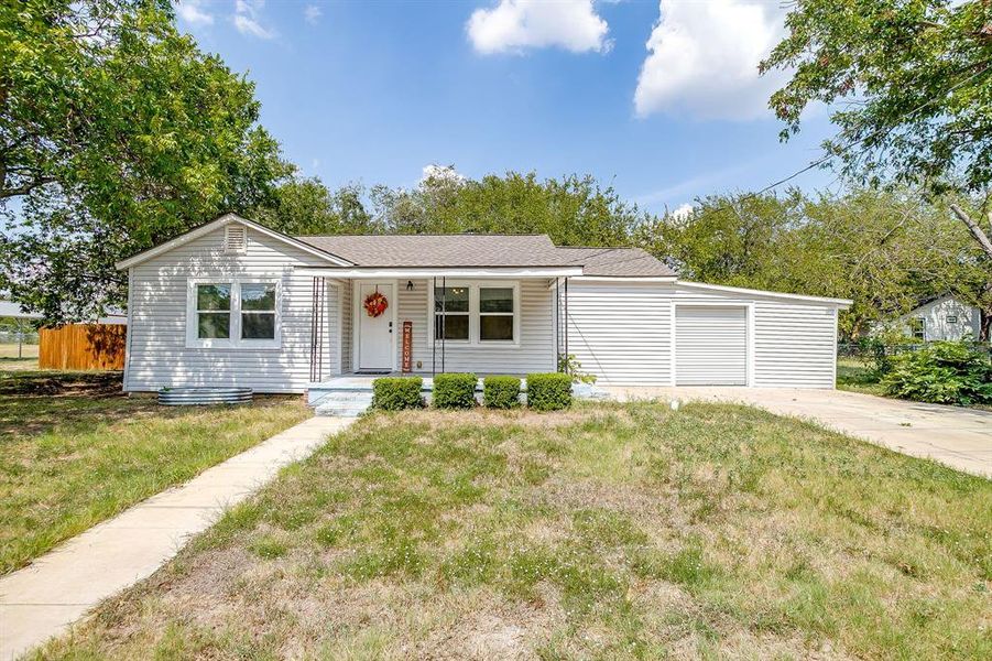 View of front facade featuring a concrete driveway, covered porch, and brand new roof