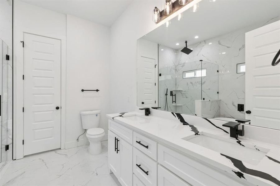 Full bath with light marble finish flooring, a marble finish shower, double vanity, and recessed lighting Full bath with light marble finish flooring, a marble finish shower, double vanity, and recessed lighting