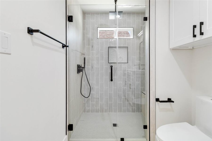 Walk-in shower with a rainfall showerhead, designed to be fully wheelchair accessible for comfort and ease of use. Walk-in shower with a rainfall showerhead, designed to be fully wheelchair accessible for comfort and ease of use.