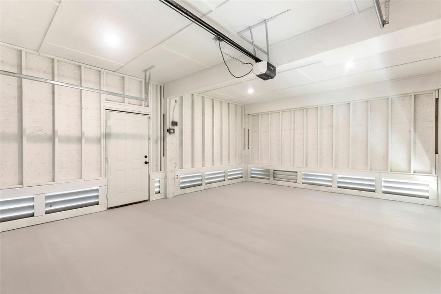 Spacious, well-lit garage with clean, white walls and ample storage potential.