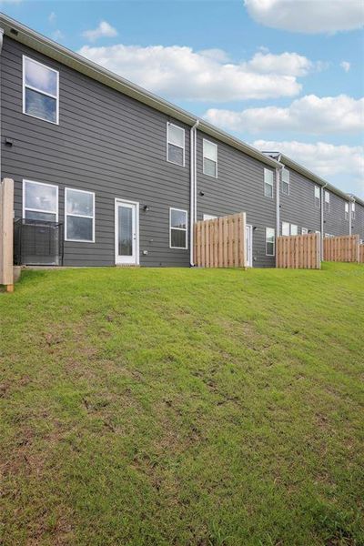 Exterior details and patio area of a home in The Enclave Townhomes, Hampton (Image 3).