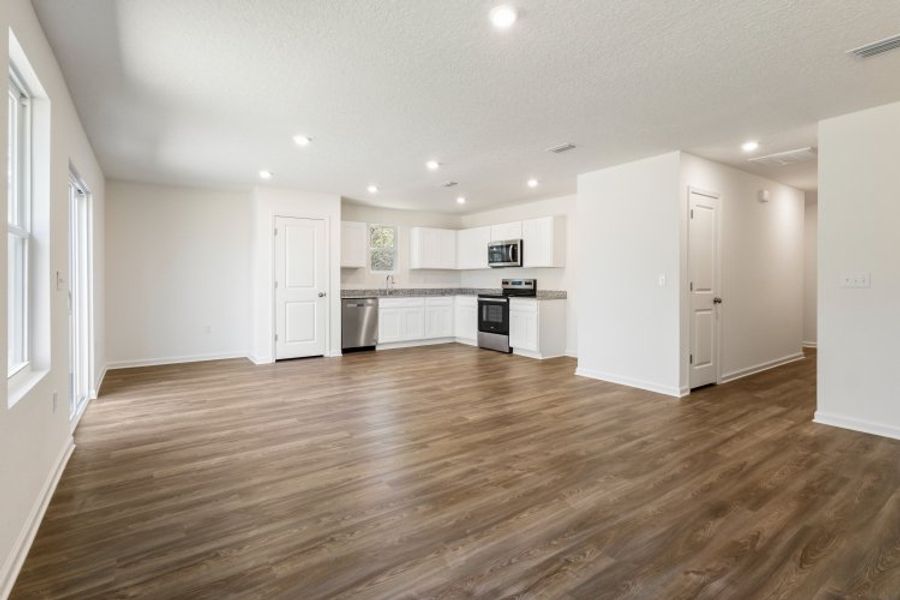 A large kitchen with white cabinets. A large kitchen with white cabinets.