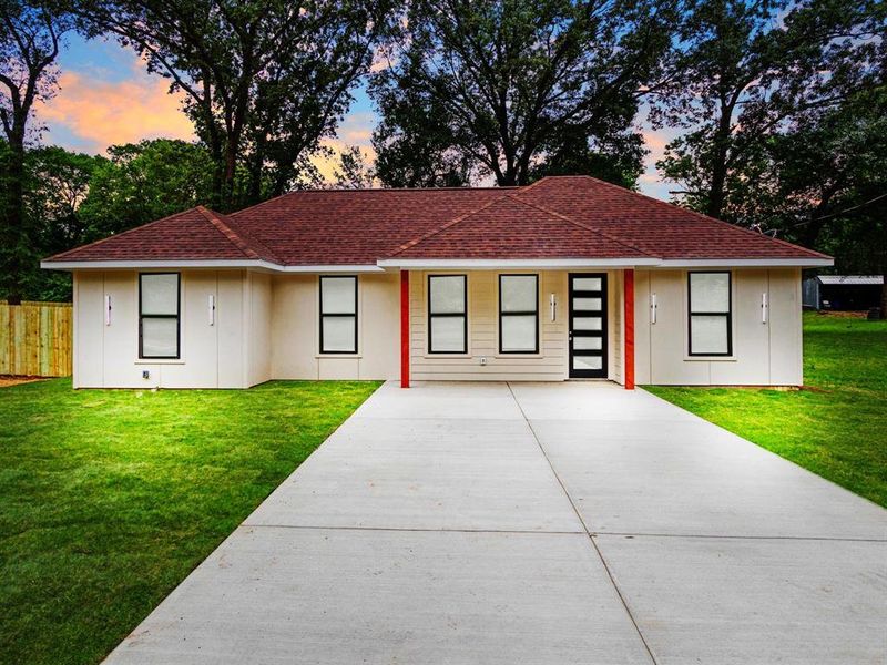 Contemporary single-story residence featuring a red shingle roof and a concrete driveway Contemporary single-story residence featuring a red shingle roof and a concrete driveway