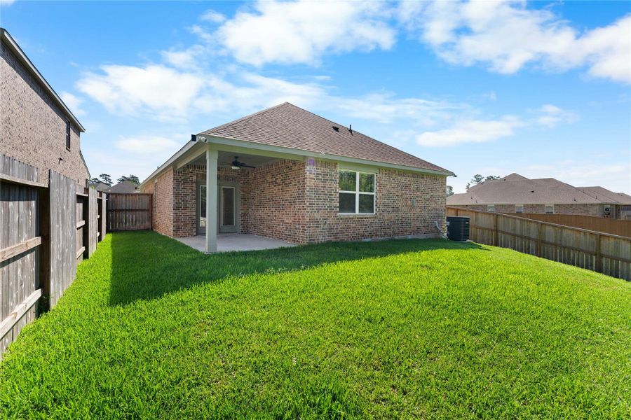 Fully fenced backyard with a covered patio, plenty of green space, and room for pets, play, or outdoor entertaining. The covered seating area provides a comfortable spot to enjoy the outdoors year-round Fully fenced backyard with a covered patio, plenty of green space, and room for pets, play, or outdoor entertaining. The covered seating area provides a comfortable spot to enjoy the outdoors year-round