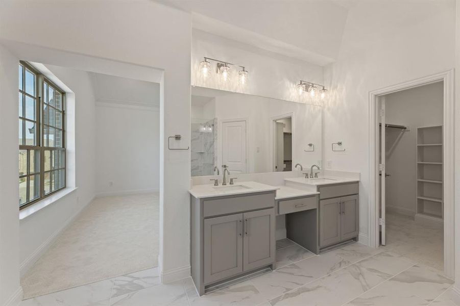 Bathroom with vanity, plenty of natural light, and tiled shower