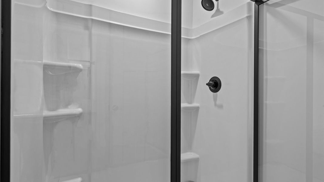 Exceptional en-suite with dual vanity and glass-enclosed walk-in shower for superior everyday comfort Exceptional en-suite with dual vanity and glass-enclosed walk-in shower for superior everyday comfort