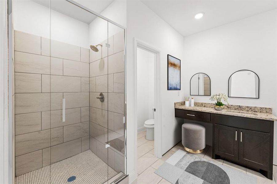 Bathroom with tile patterned flooring, a shower with door, toilet, and vanity