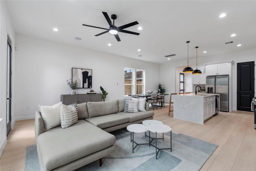 Full view of the main floor blending kitchen, dining, and living in one open space. Full view of the main floor blending kitchen, dining, and living in one open space.