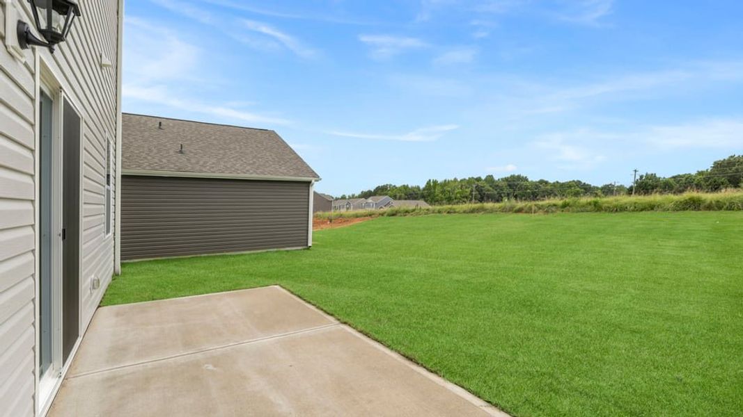 Exterior details and patio area of a home in Durbin Meadows Traditions, Fountain Inn (Image 22).