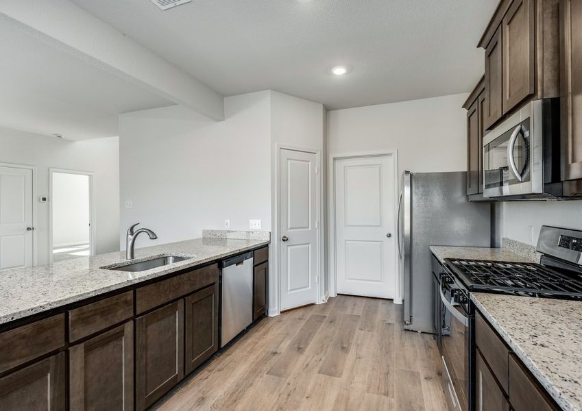 The kitchen has beautiful wood cabinetry.