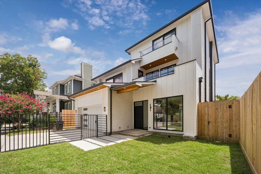 Striking modern home with refined lines, large windows, and a gated driveway, offering both style and privacy. Striking modern home with refined lines, large windows, and a gated driveway, offering both style and privacy.