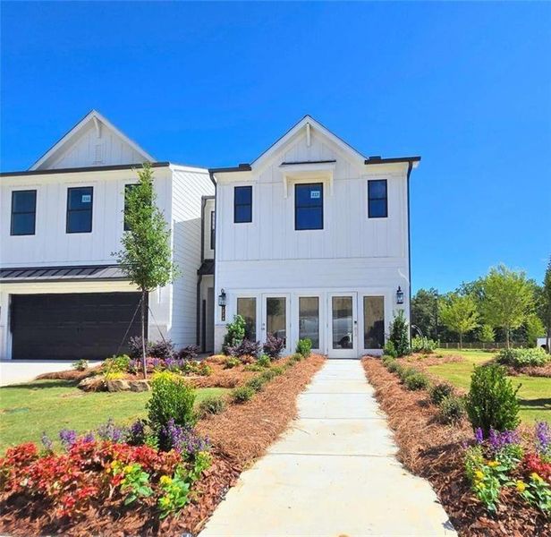 Front exterior of a new home in Sherwood Square, Flowery Branch, GA, highlighting curb appeal (Image 1). Front exterior of a new home in Sherwood Square, Flowery Branch, GA, highlighting curb appeal (Image 1).