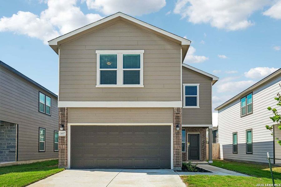 Front exterior of a new home in Medina Crossing, Von Ormy, TX, highlighting curb appeal (Image 16).