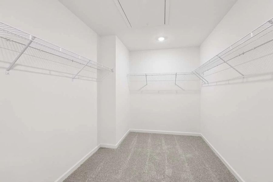 Sample Photo: Primary Bedroom Walk-In Closet Sample Photo: Primary Bedroom Walk-In Closet