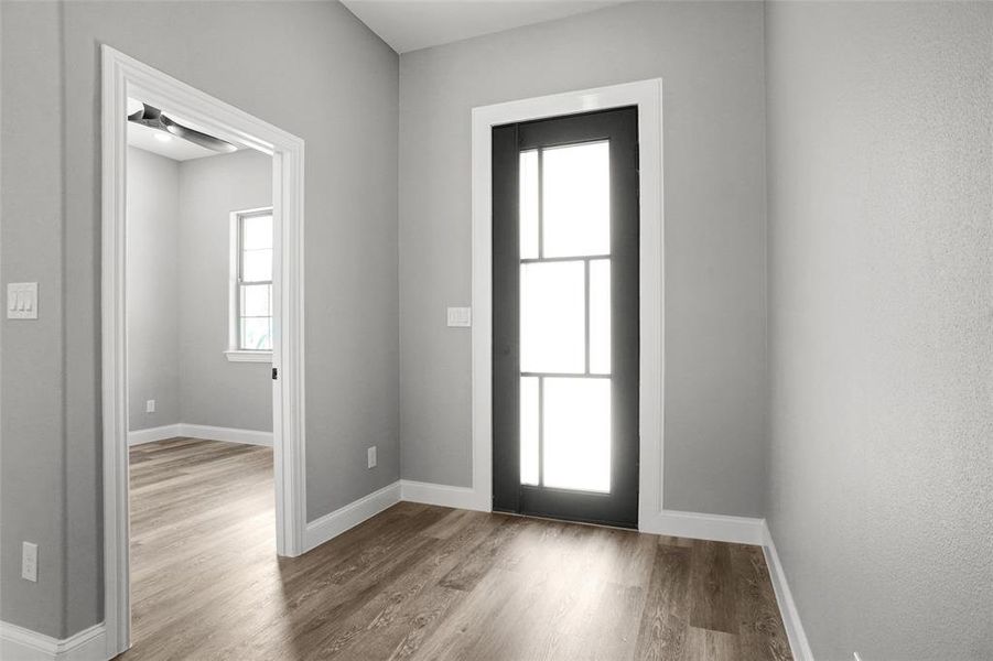 Foyer featuring wood finished floors and baseboards Foyer featuring wood finished floors and baseboards