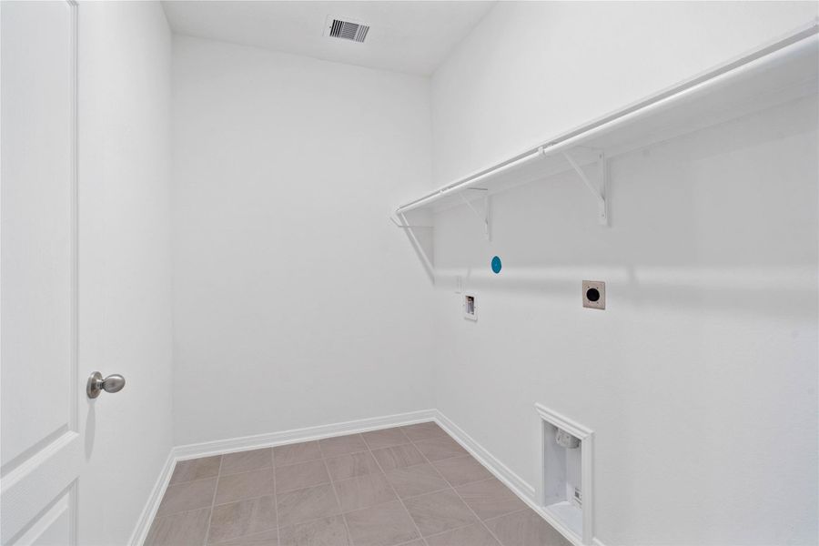 Beyond the kitchen is the laundry room which features a streamlined shelf to keep all your essentials neatly within reach. Beyond the kitchen is the laundry room which features a streamlined shelf to keep all your essentials neatly within reach.