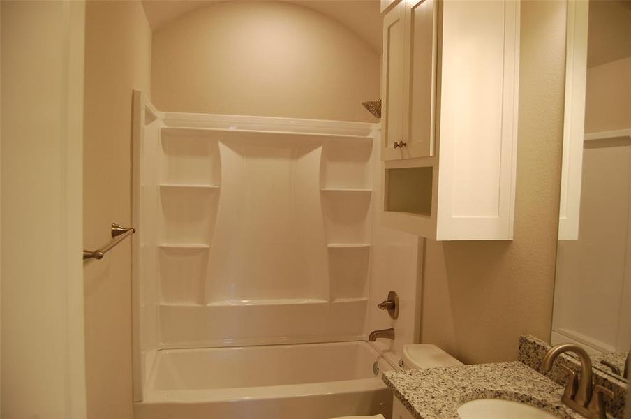 Full bathroom featuring vanity, toilet, and bathing tub / shower combination