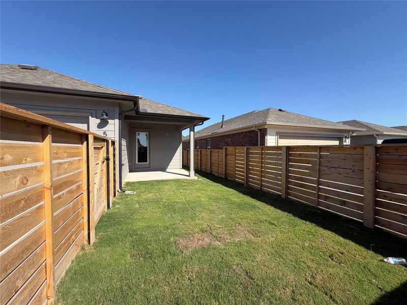 Fenced backyard with a patio Fenced backyard with a patio