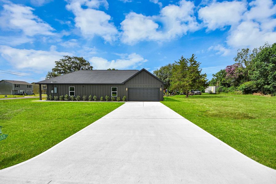 Modern exterior with a long driveway and attached two-car garage. Modern exterior with a long driveway and attached two-car garage.