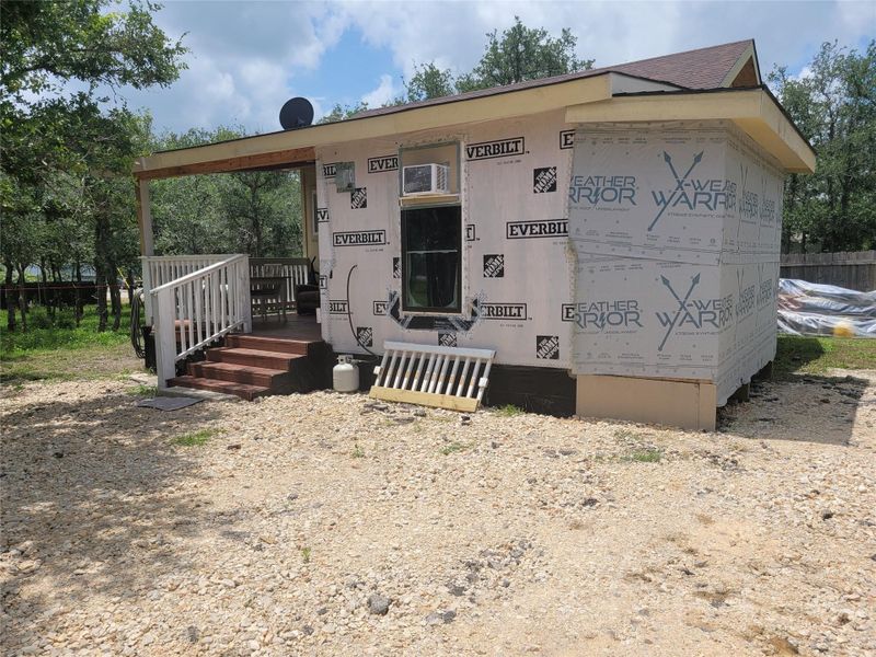 A private gravel driveway leads to a cozy dwelling nestled among mature trees. A private gravel driveway leads to a cozy dwelling nestled among mature trees.