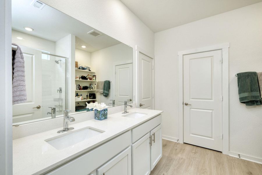 Bathroom featuring a stall shower, visible vents, and a sink