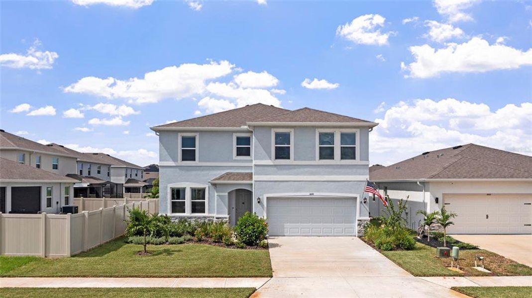 Front exterior of a new home in Silverstone North, Palmetto, FL, highlighting curb appeal (Image 26). Front exterior of a new home in Silverstone North, Palmetto, FL, highlighting curb appeal (Image 26).