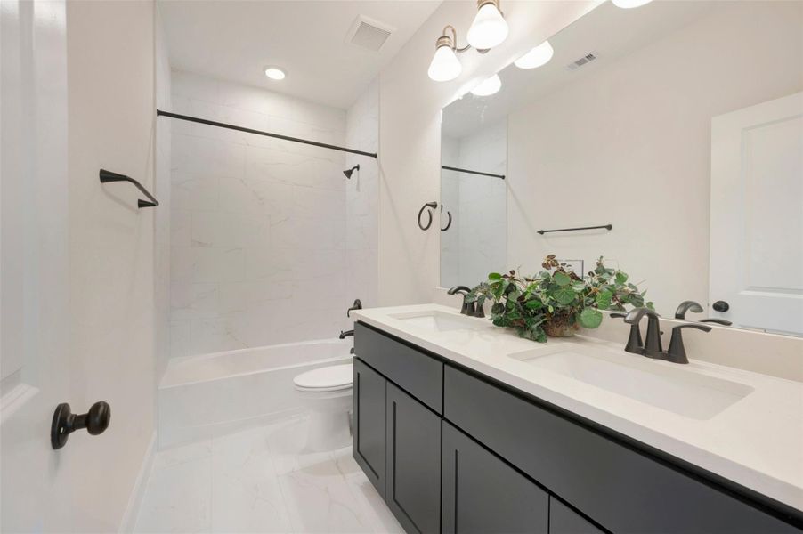 Large 2ndary bath at 2nd floor - with quartz counters and tile to ceiling.