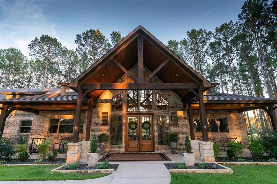 Grand Resort style entry with high vaulted pine ceiling.  Sees through to other side to the lake.  Wings of the porch have space for porch swings.