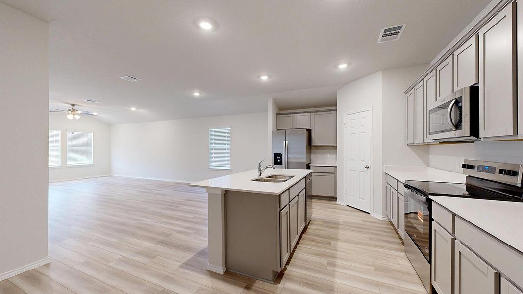 An open-concept living area flows seamlessly into a well-appointed kitchen, ideal for modern entertaining.