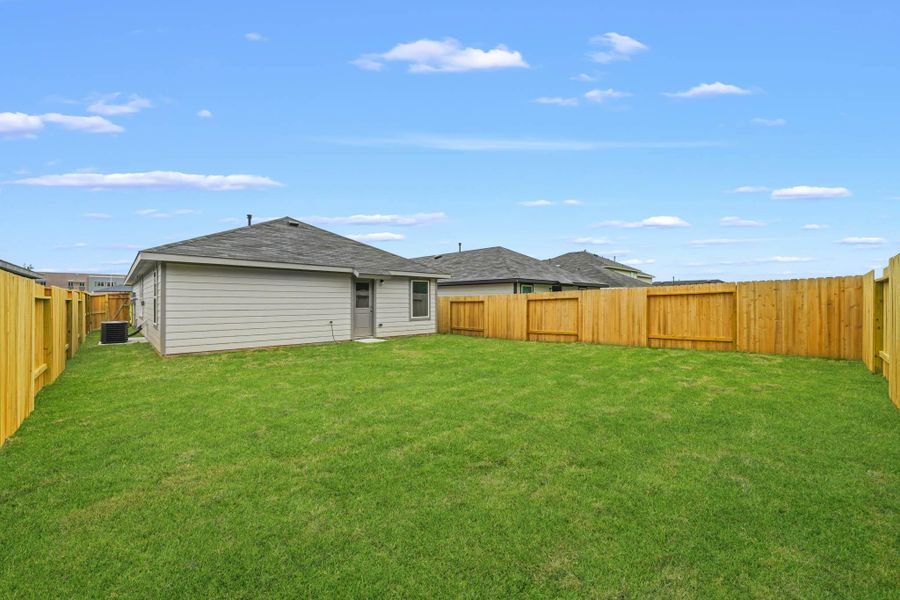 Exterior details and patio area of a home in The Canopies, Splendora (Image 17).