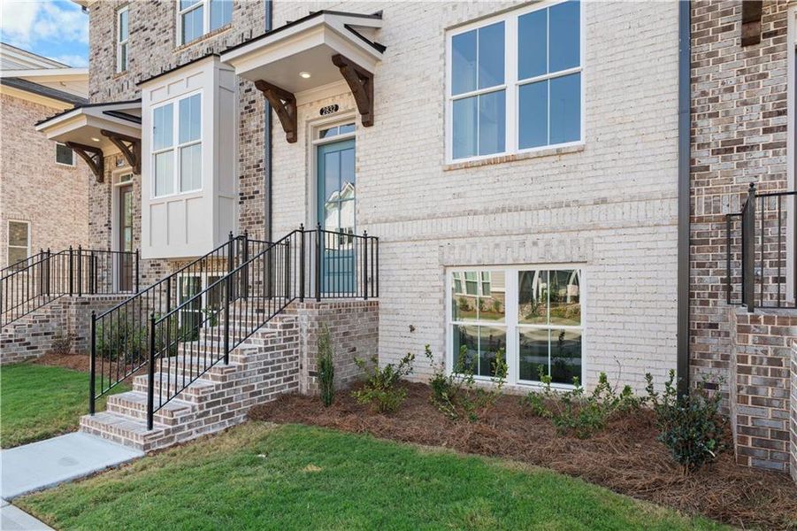 Exterior details and patio area of a home in Evanshire Townhomes, Duluth (Image 2).