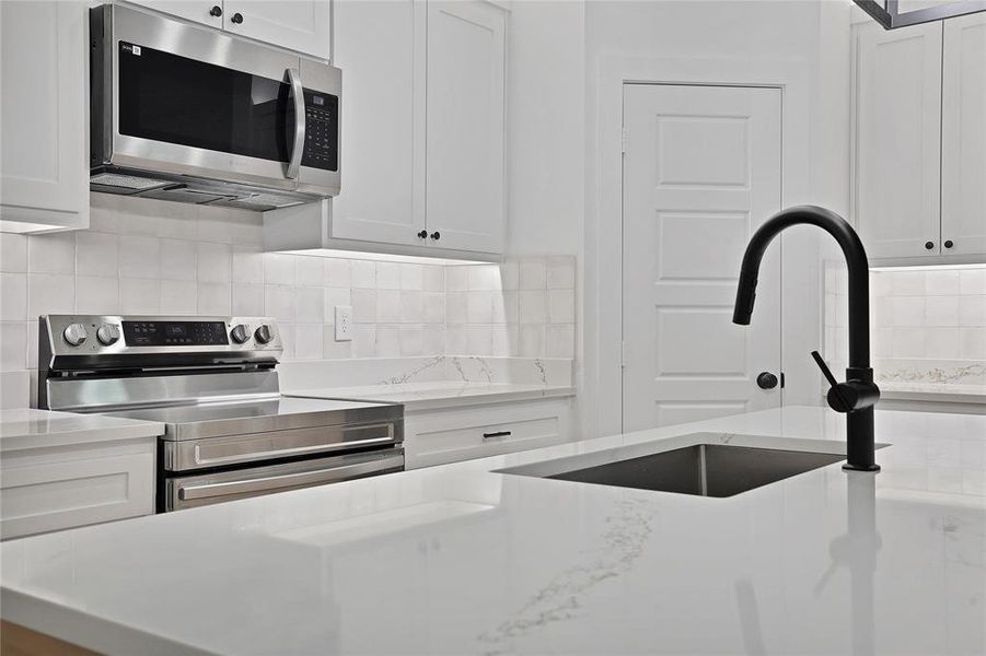 Kitchen featuring backsplash.