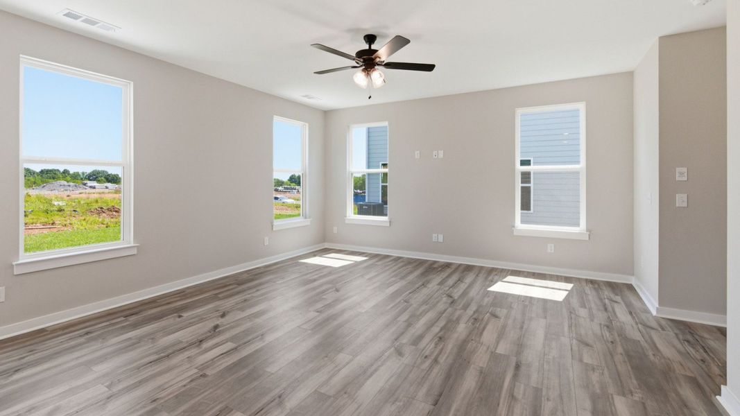 Gathering room with hard surface flooring, windows, and ceiling fan Gathering room with hard surface flooring, windows, and ceiling fan
