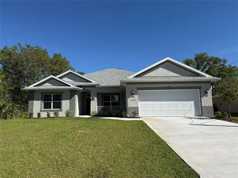 Front exterior of a new home in , North Port, FL, highlighting curb appeal (Image 1). Front exterior of a new home in , North Port, FL, highlighting curb appeal (Image 1).