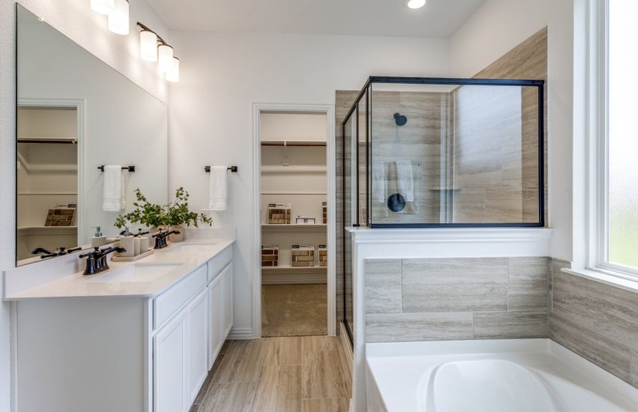 Luxury owner's bath with shower, tub, and double vanity