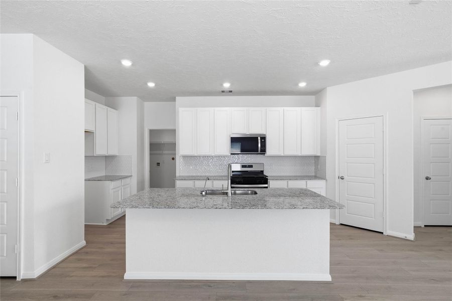 This spacious kitchen has it all—ample storage, generous counter space, and a layout that truly makes it the heart of the home. This spacious kitchen has it all—ample storage, generous counter space, and a layout that truly makes it the heart of the home.