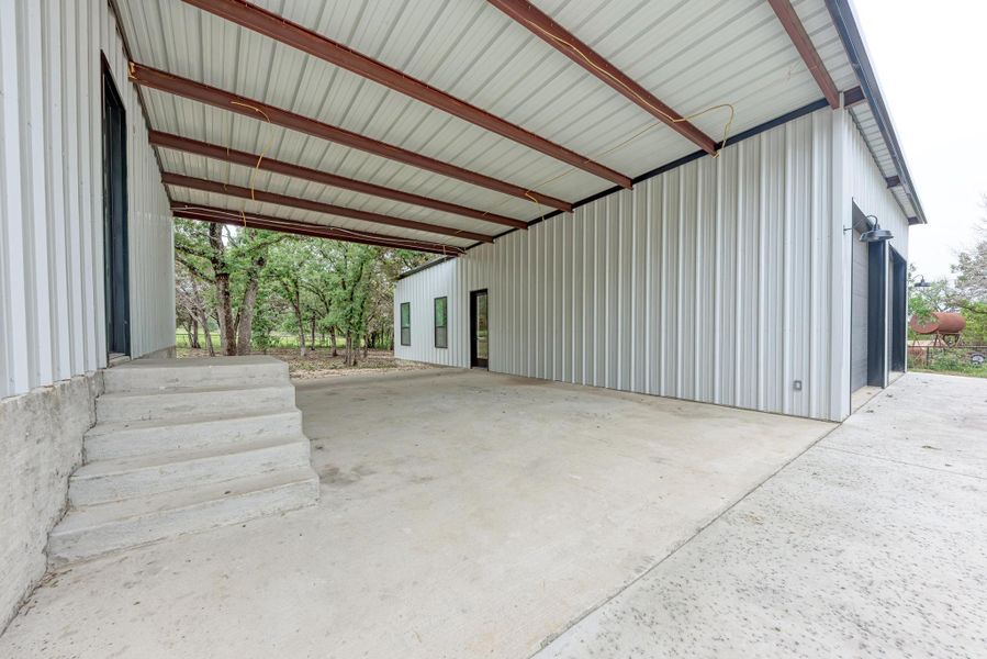 Garage featuring an attached carport
