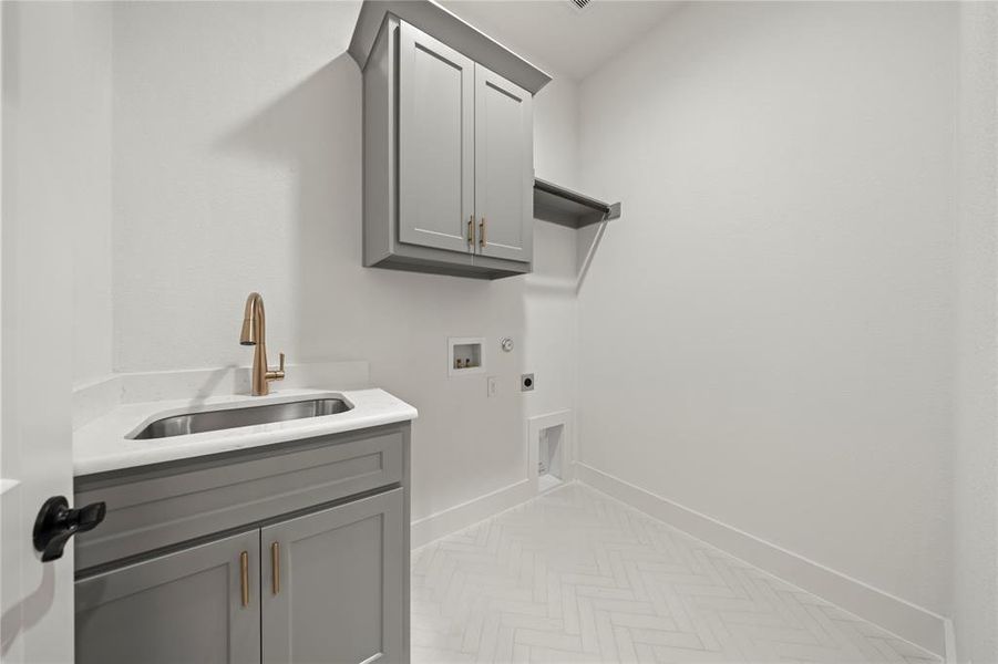 Laundry area featuring hookup for a washing machine, hookup for an electric dryer, hookup for a gas dryer, and cabinet space