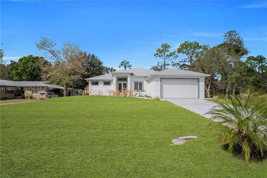 Front exterior of a new home in , Lehigh Acres, FL, highlighting curb appeal (Image 24).