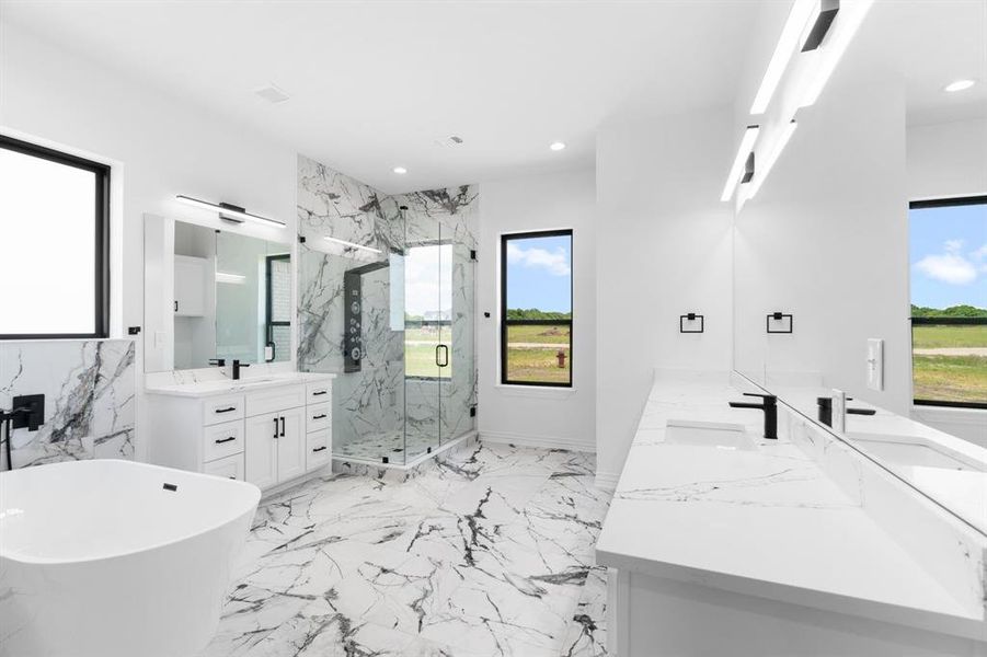 Bathroom featuring a marble finish shower, double vanity, a soaking tub, recessed lighting, and marble tiled floors Bathroom featuring a marble finish shower, double vanity, a soaking tub, recessed lighting, and marble tiled floors