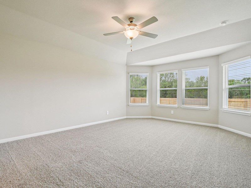 Spare room featuring light colored carpet and a ceiling fan Spare room featuring light colored carpet and a ceiling fan