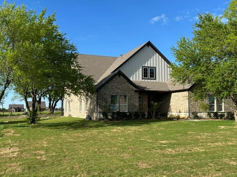 Front exterior of a new home in Fannin Ranch, Leonard, TX, highlighting curb appeal (Image 18).