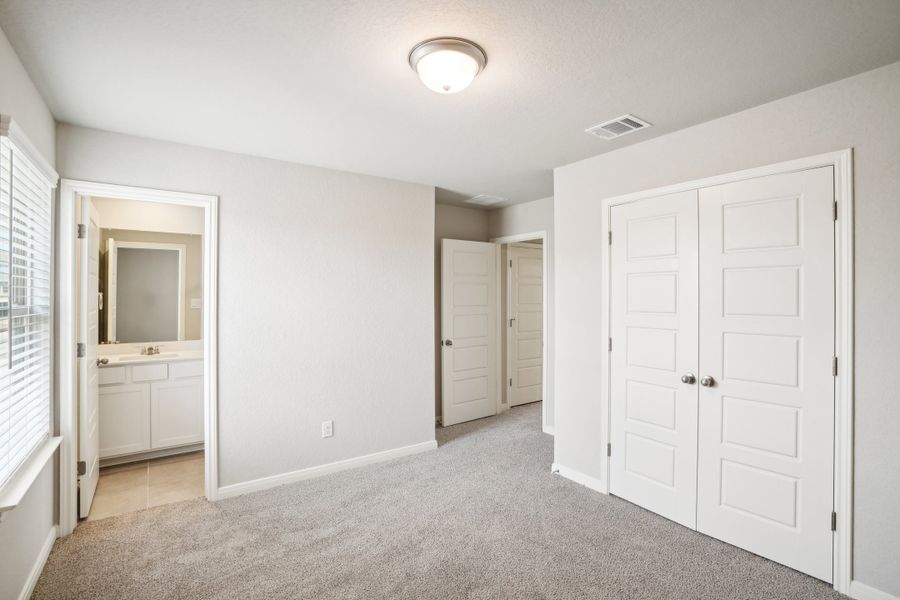 Guest bedroom of the Reynolds floorplan at a Meritage Homes community.