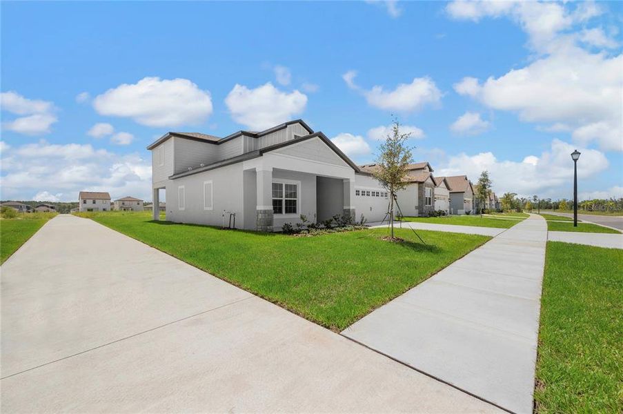 Front exterior of a new home in Gum Lake Preserve, Lake Alfred, FL, highlighting curb appeal (Image 18).